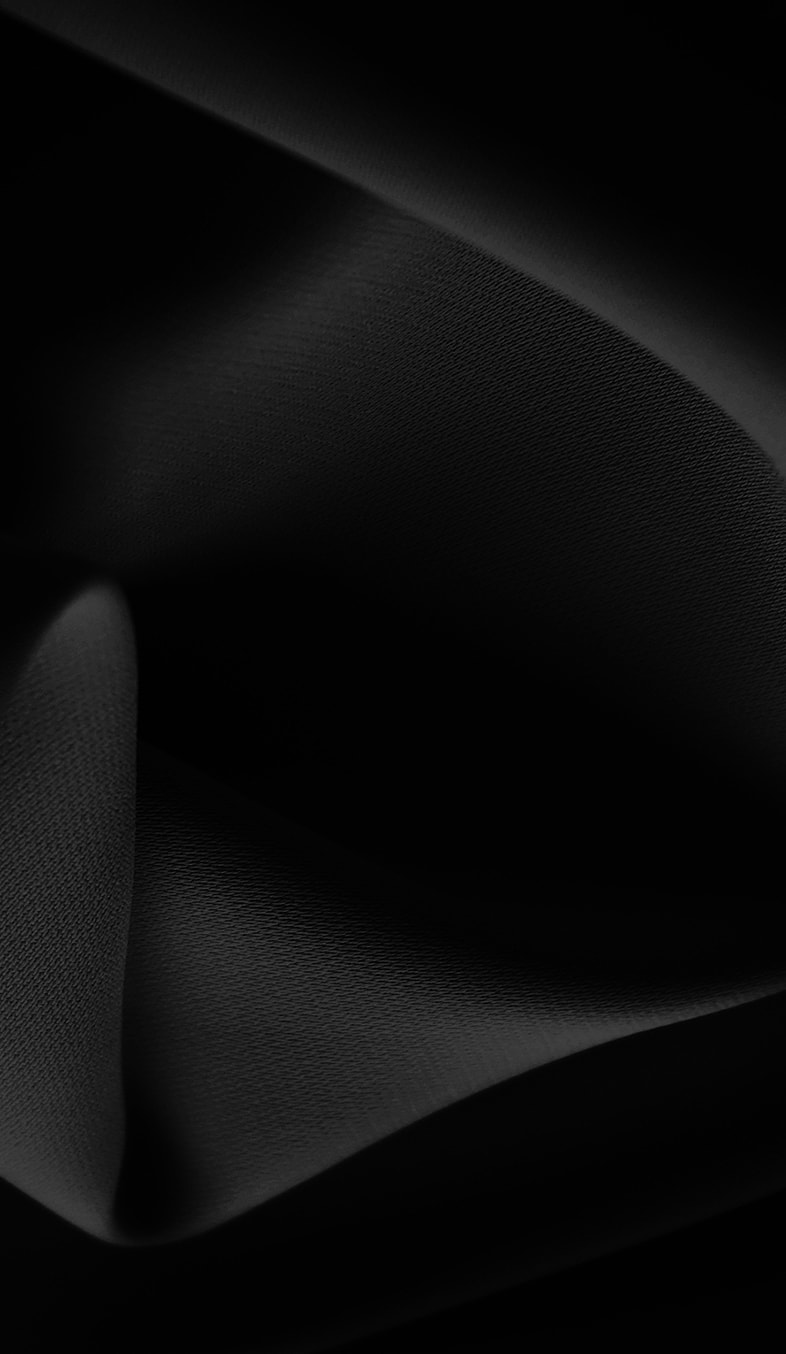 Black fabric texture with soft folds and shadows