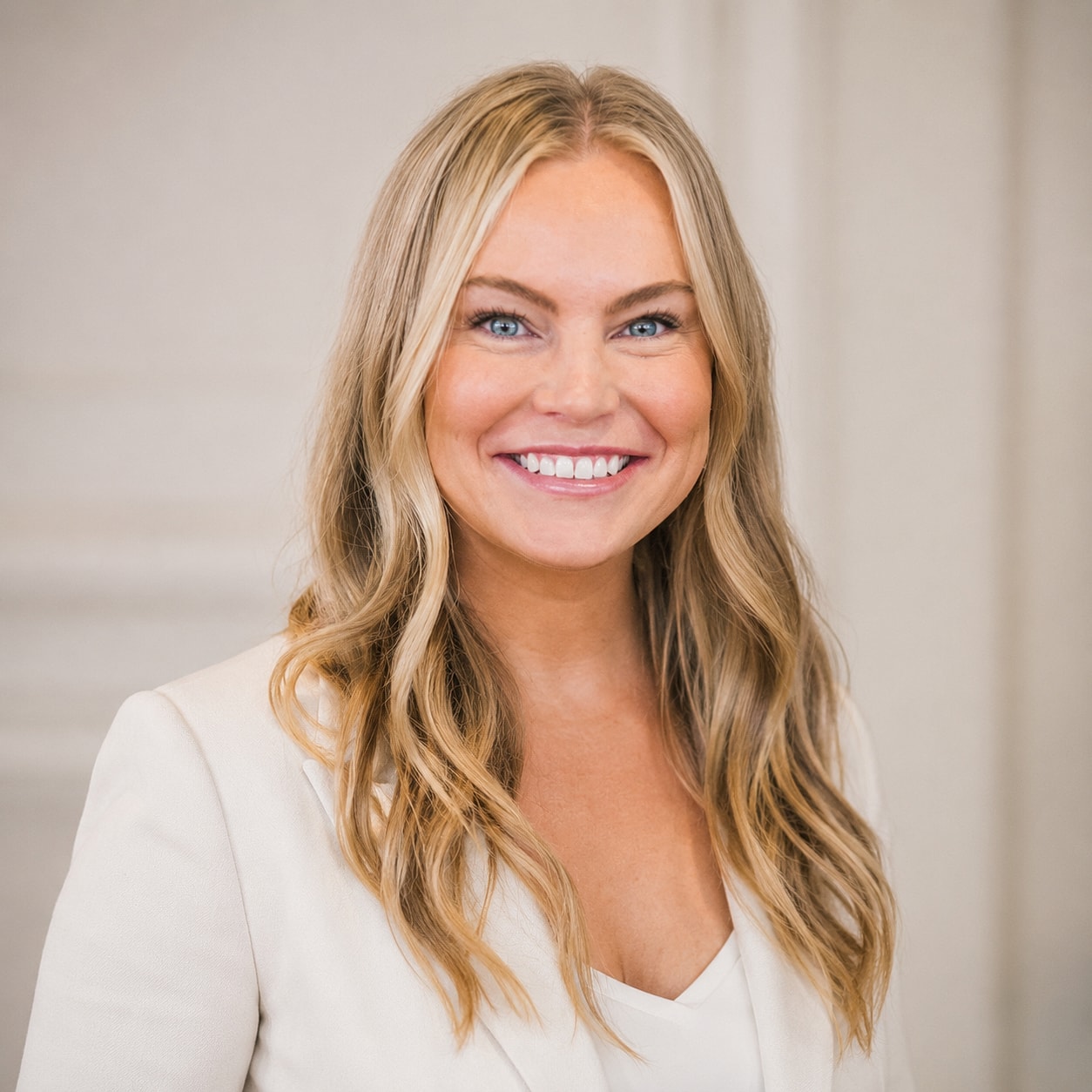 Smiling woman in a professional outfit.