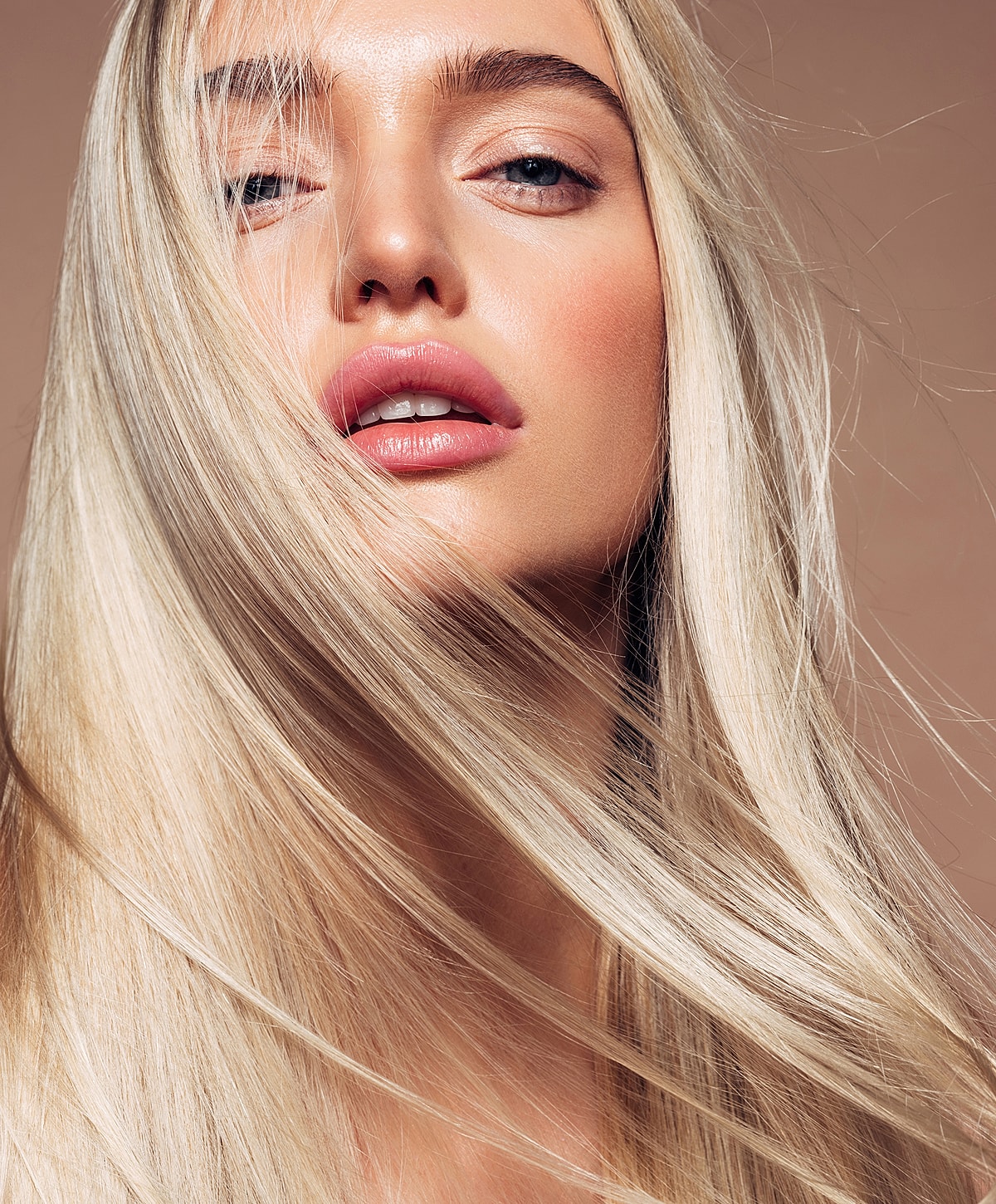 Portrait of a woman with flowing blonde hair.