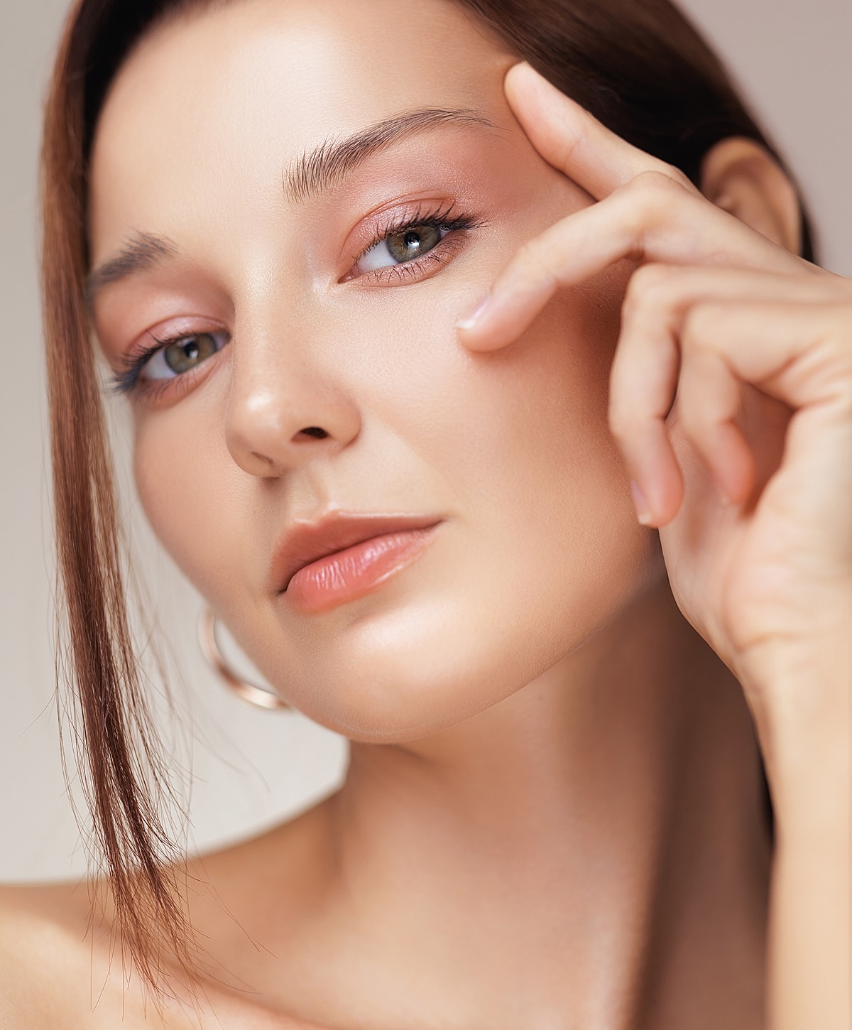 Close-up of a woman’s face with soft makeup.