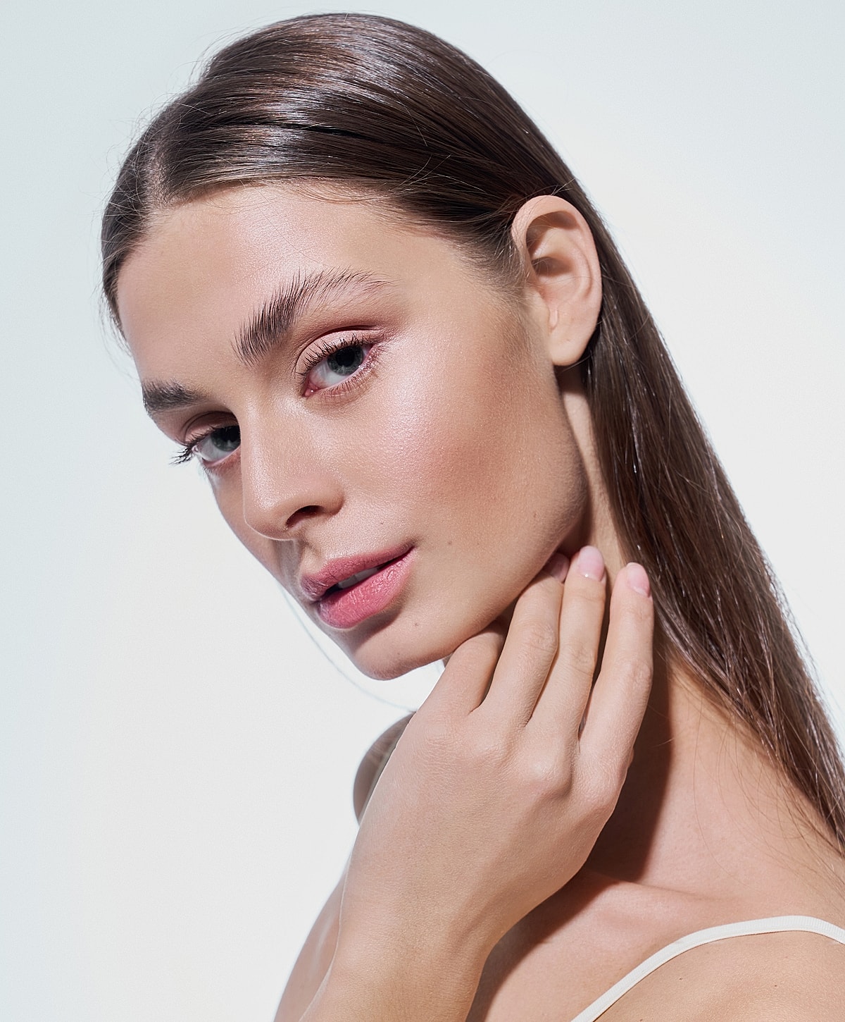 Close-up of a woman with glowing skin.