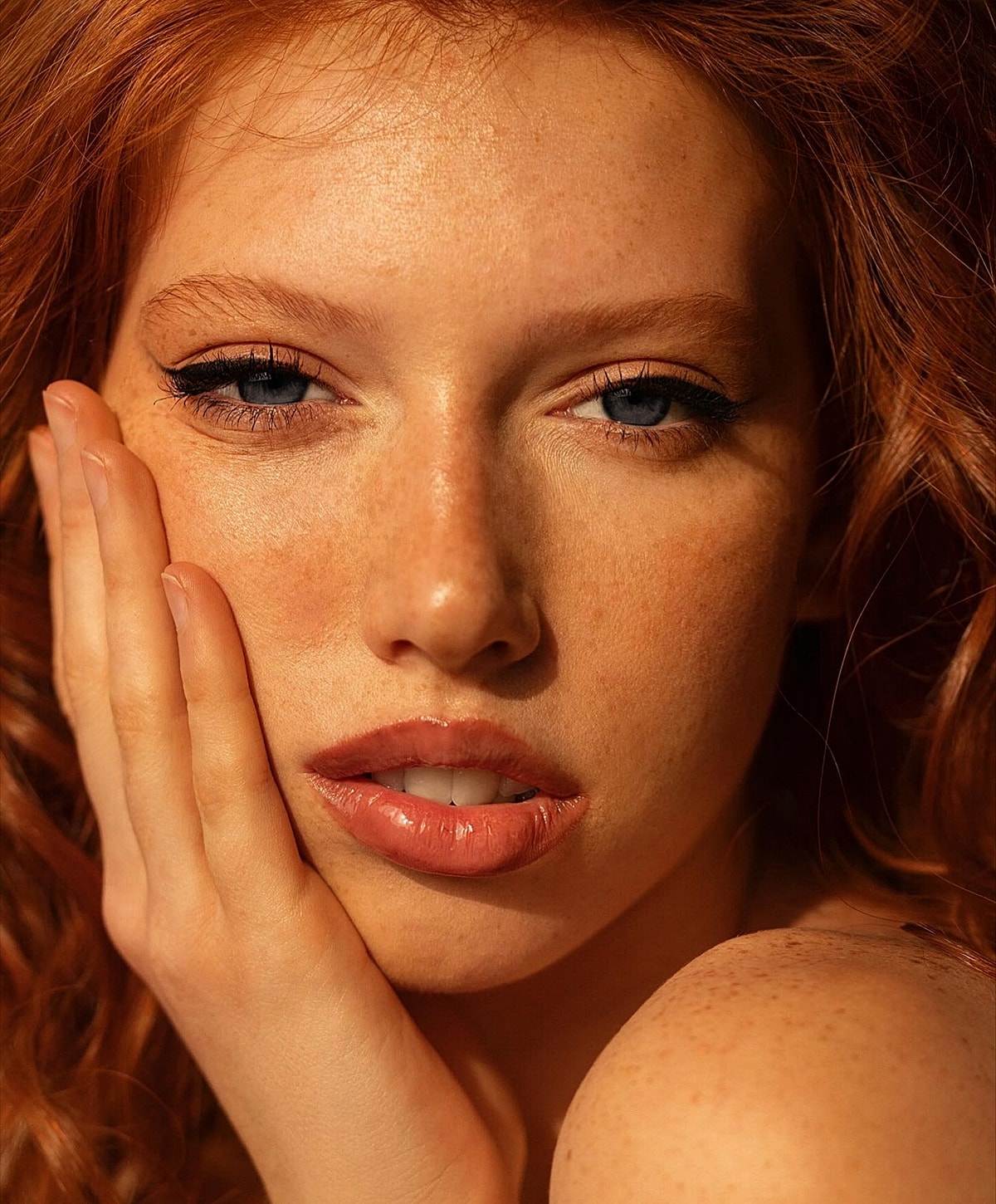 Close-up of a person with red hair and freckles.