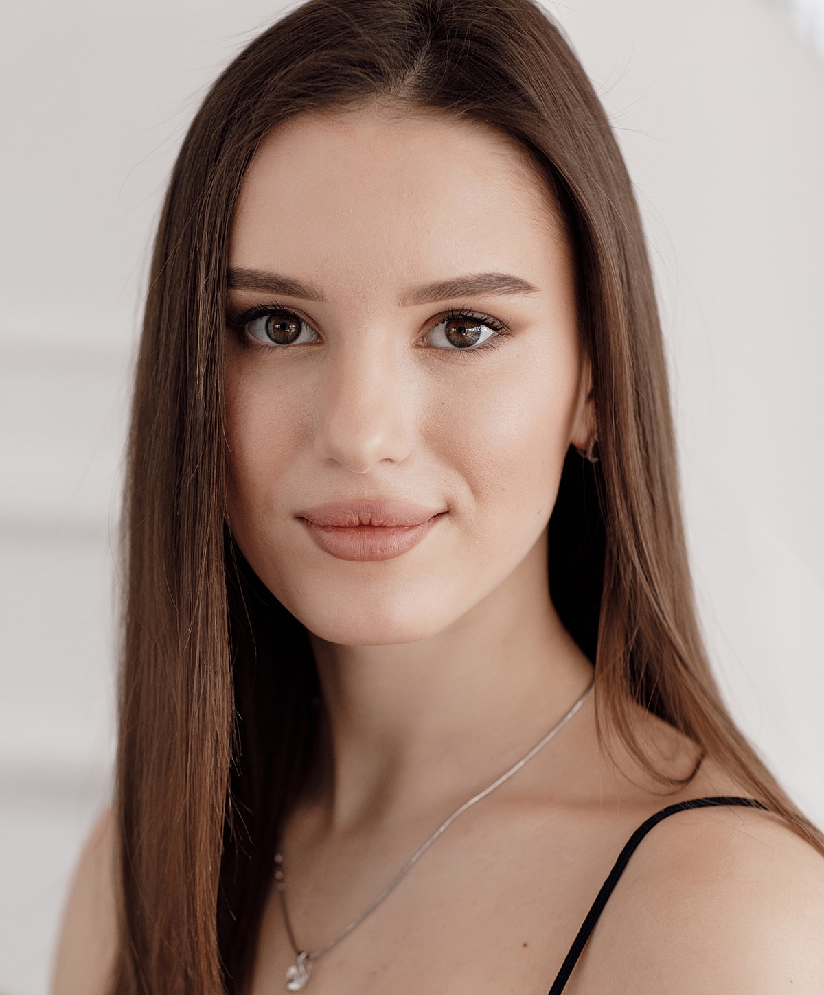 Portrait of a woman with long brown hair.