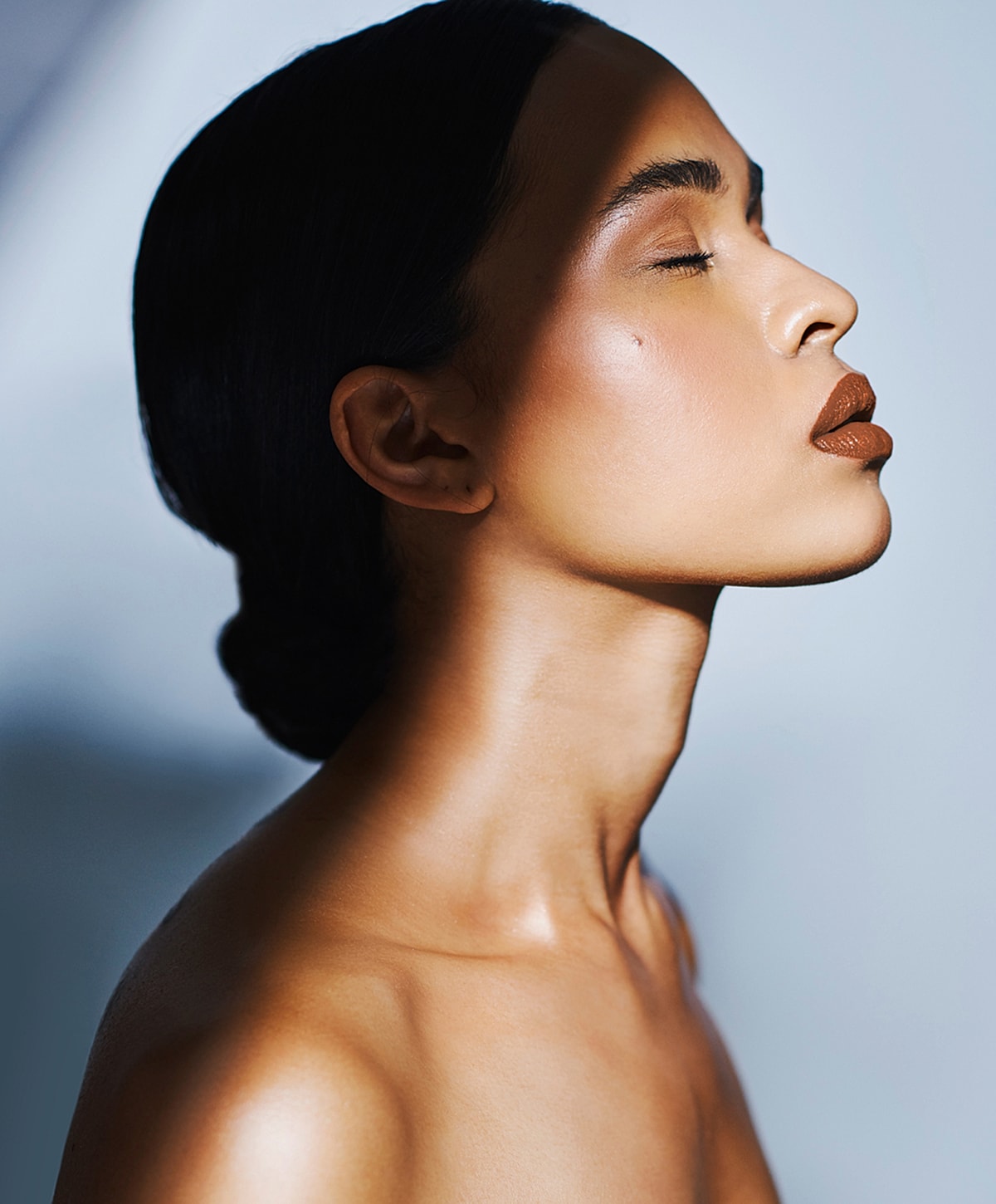 Profile of a woman with golden skin tone.