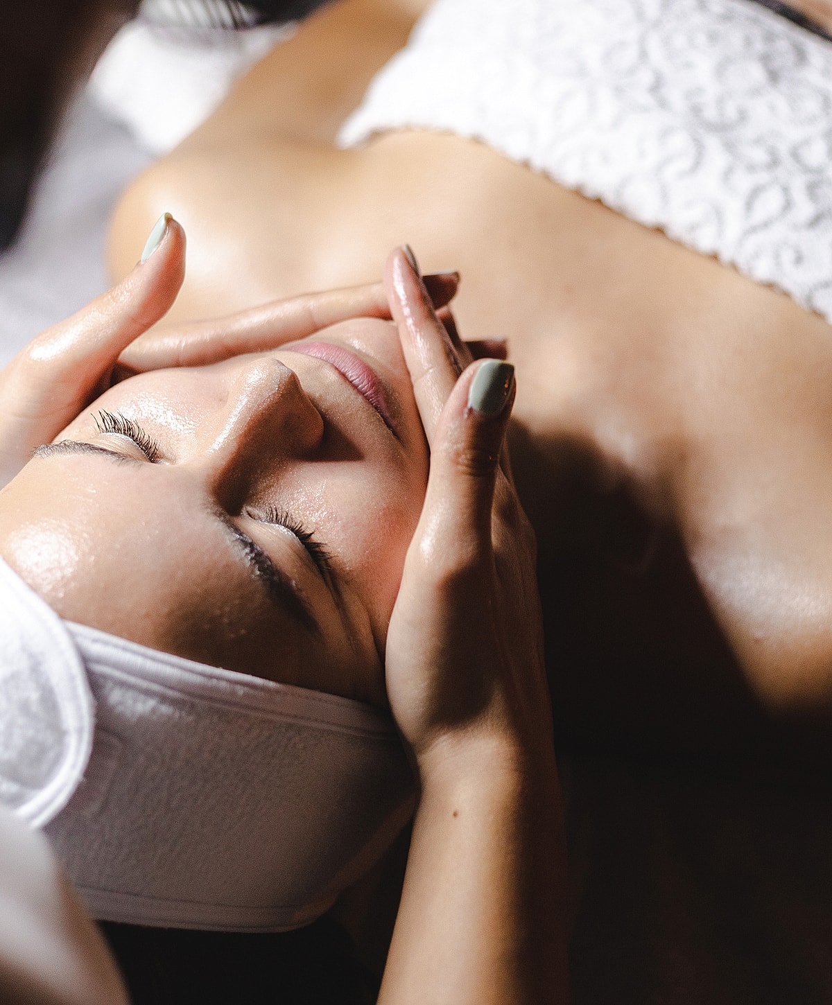 Person receiving a soothing facial treatment.