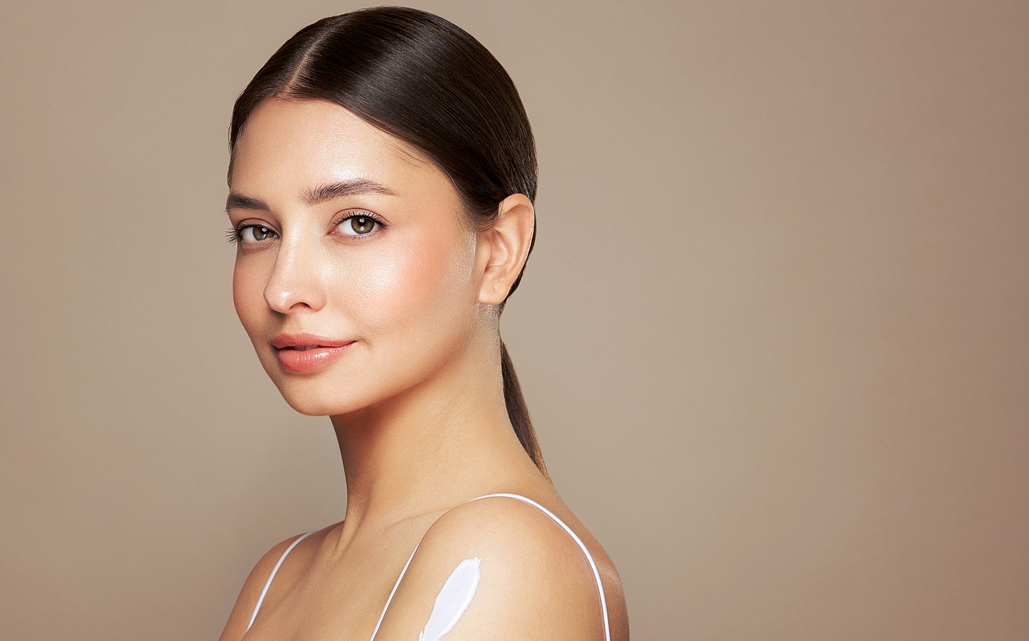 Woman with flawless skin and light makeup.