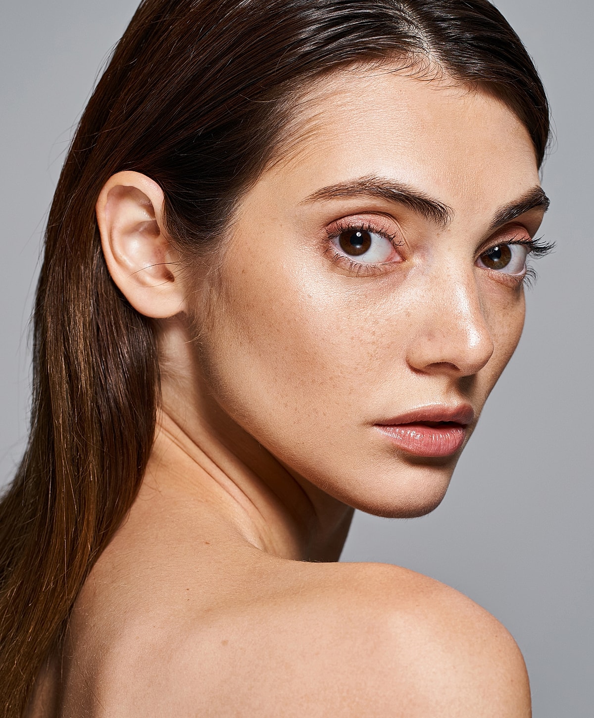 Close-up of a woman with freckled skin.