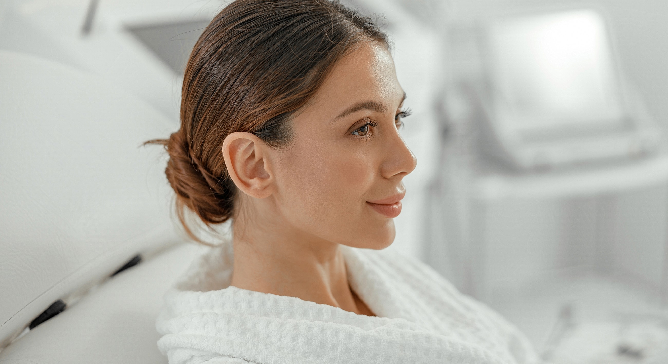 Woman wearing a robe in a calm setting.