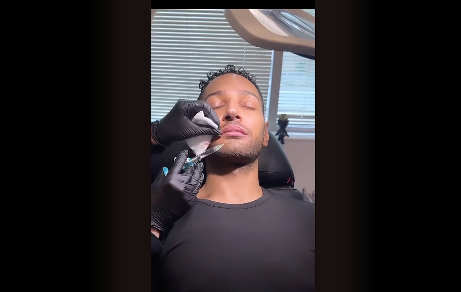 Man receiving cosmetic lip treatment in clinic.